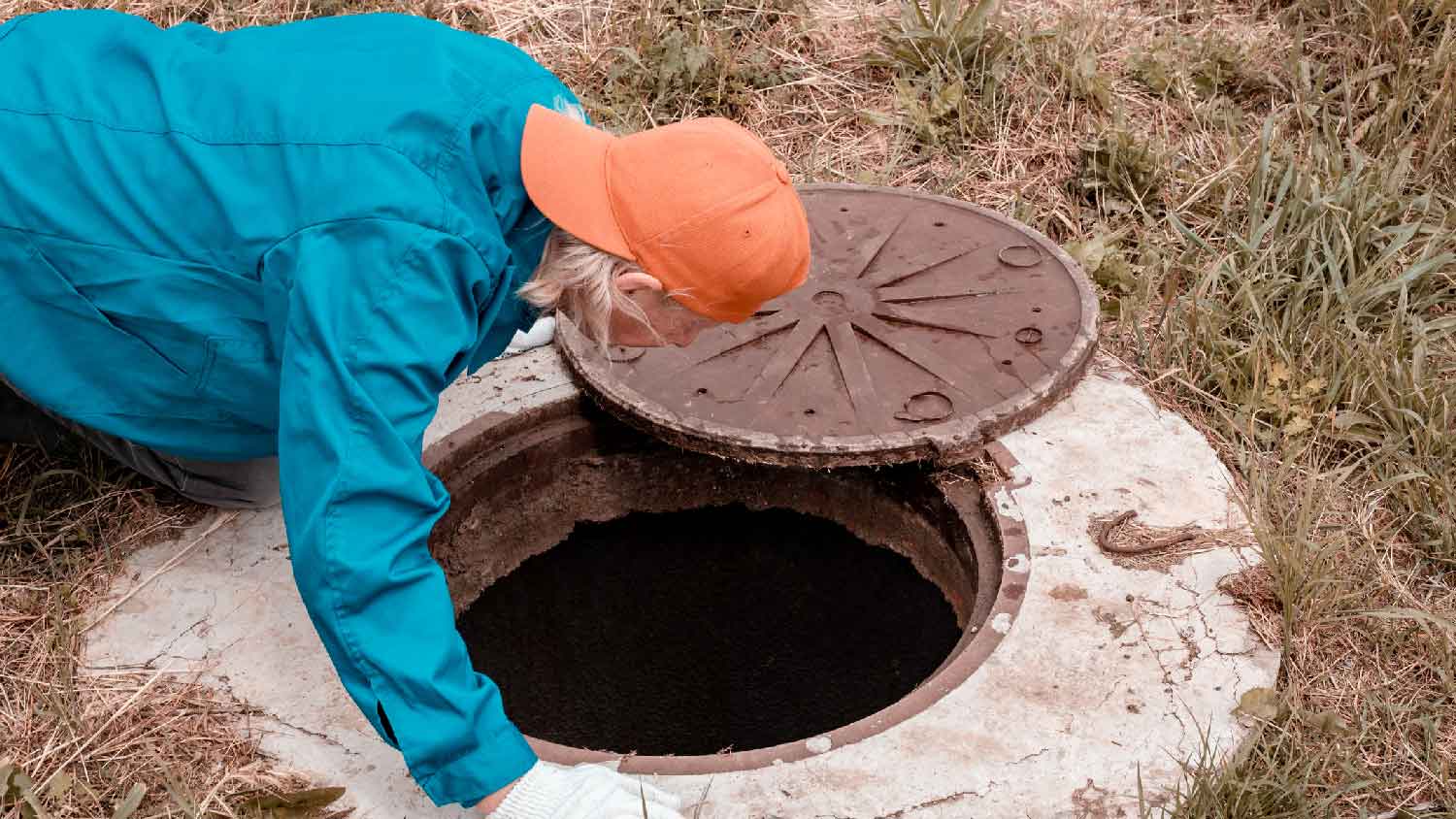 A professional inspecting a septic system