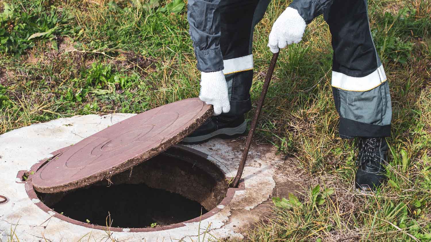 A professional inspecting a house’s septic system