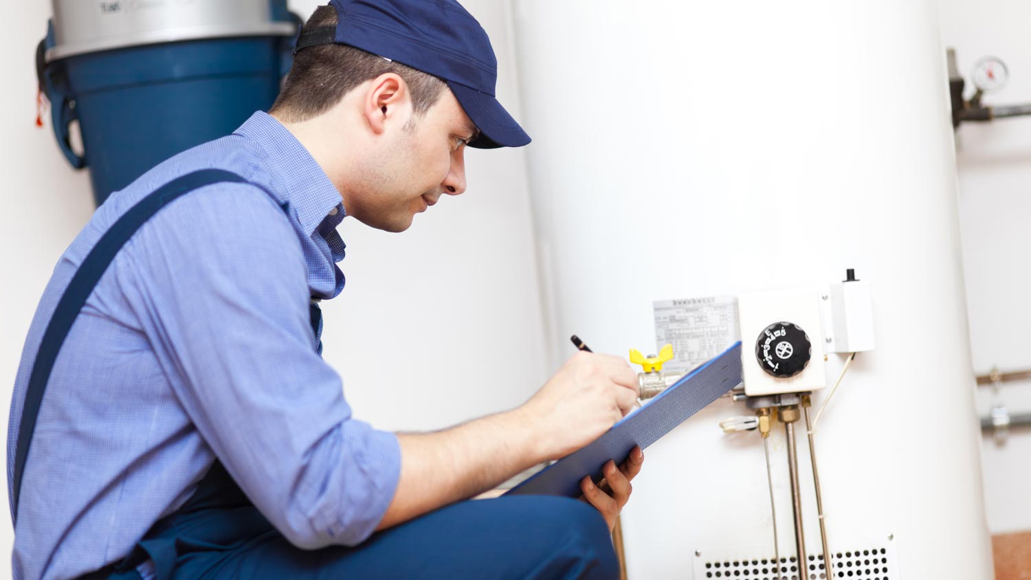 A professional inspecting a water heater