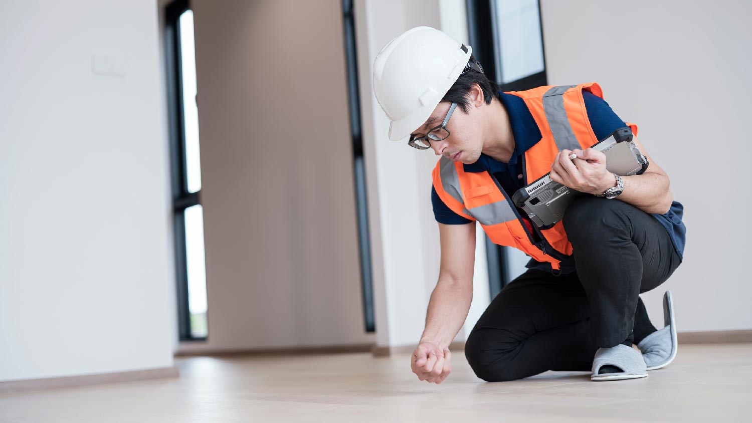 A professional inspecting wooden flooring