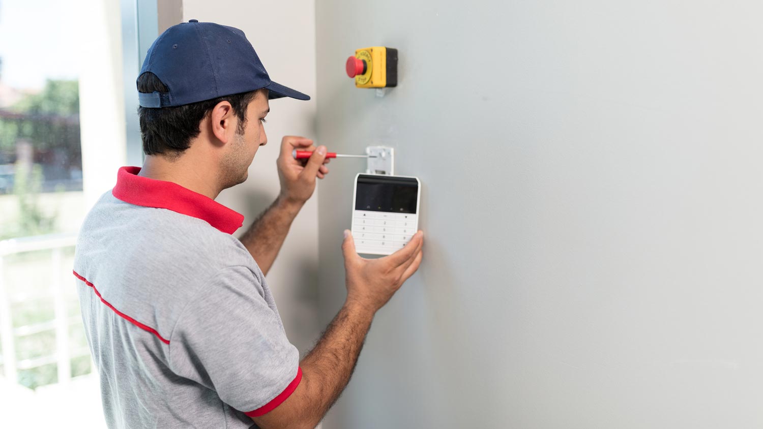 A professional installing a cellular monitoring