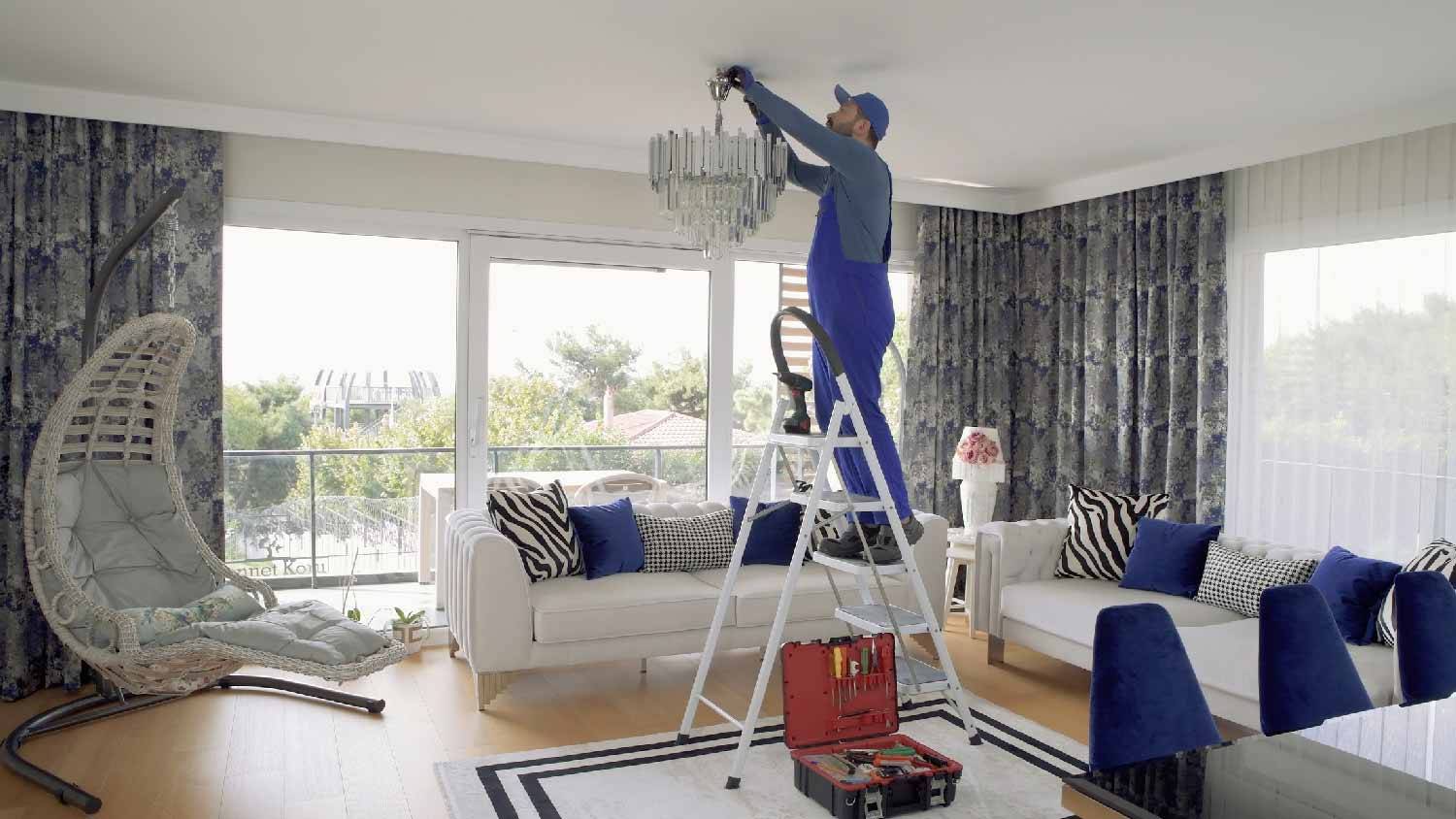 A professional installing a chandelier