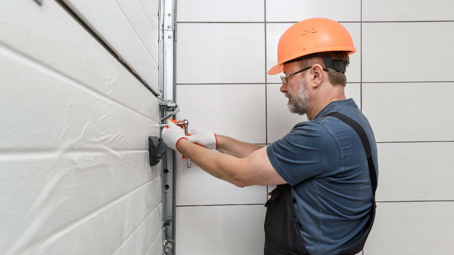 A professional installing a garage door