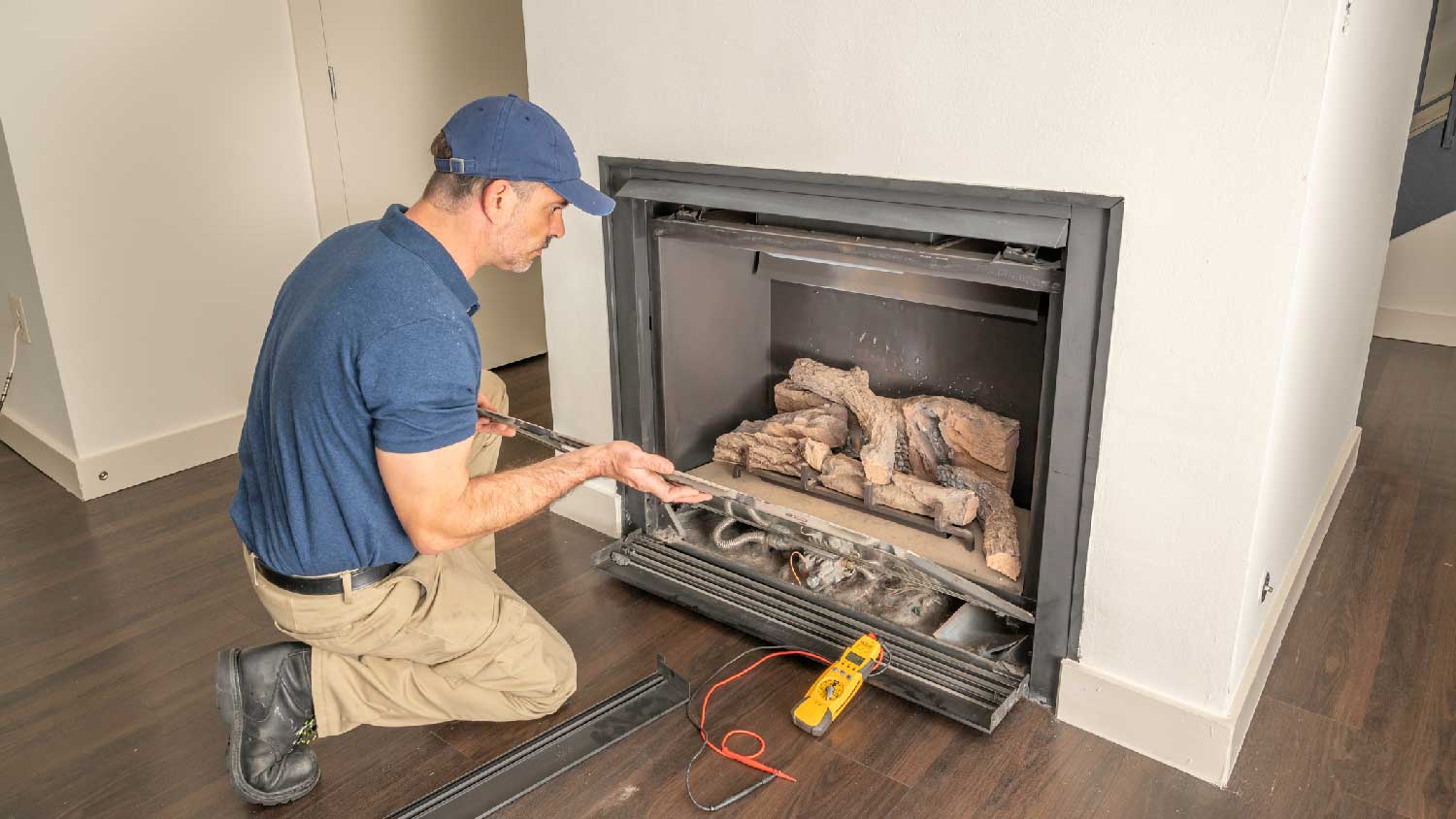 A professional installing a gas fireplace