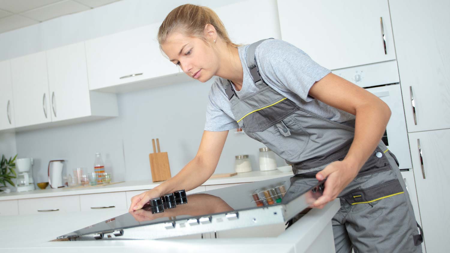 A professional installing a ceramic glass stove top