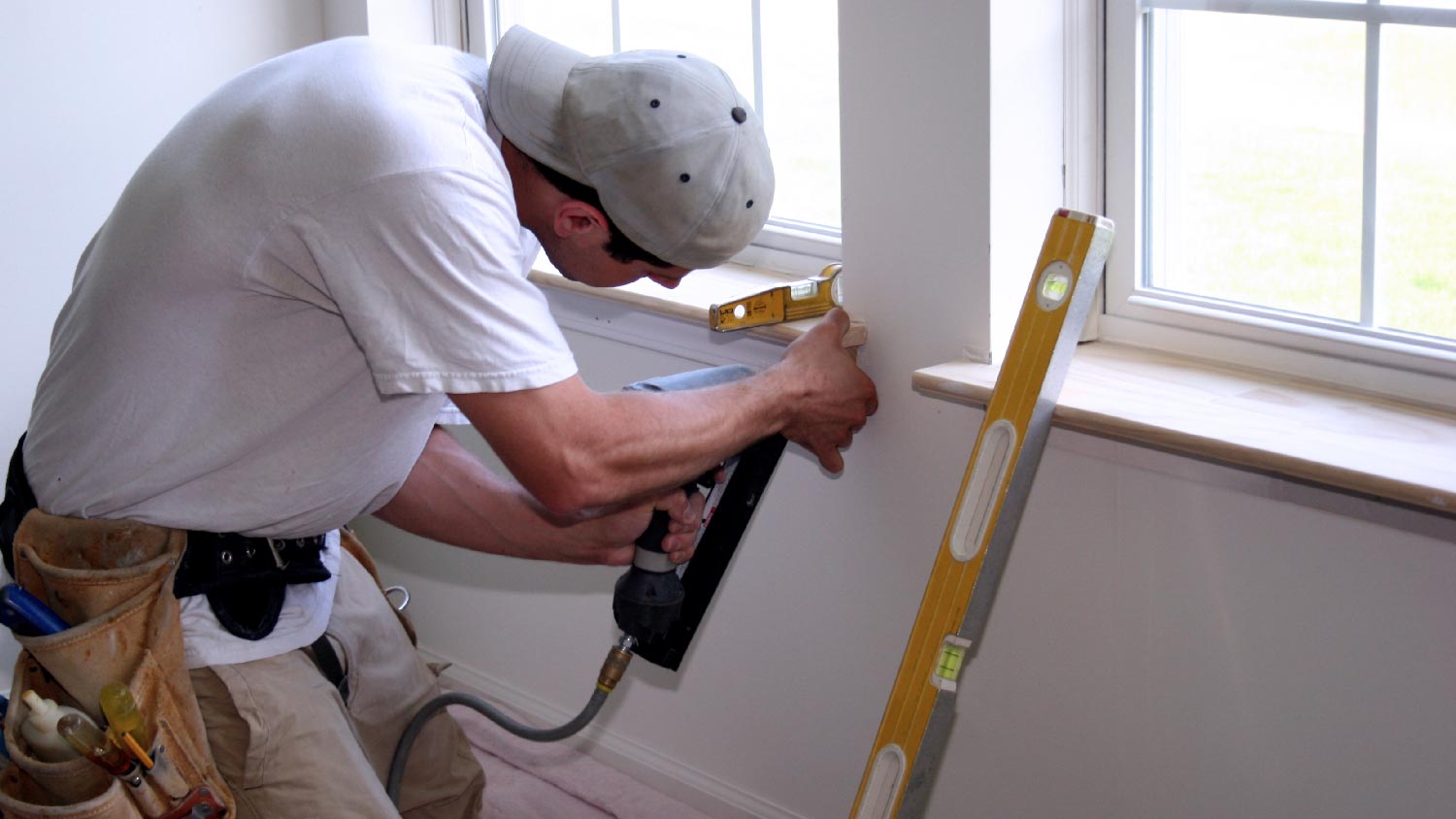 A professional installing a new window sill