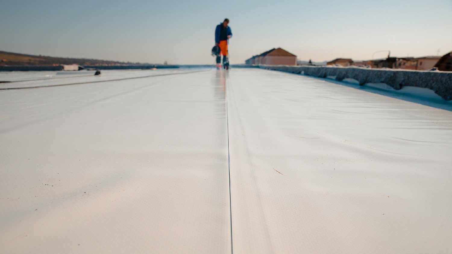 A professional installing PVC roofing