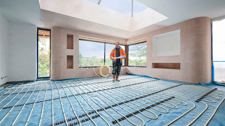 A professional installing radiant floor heating