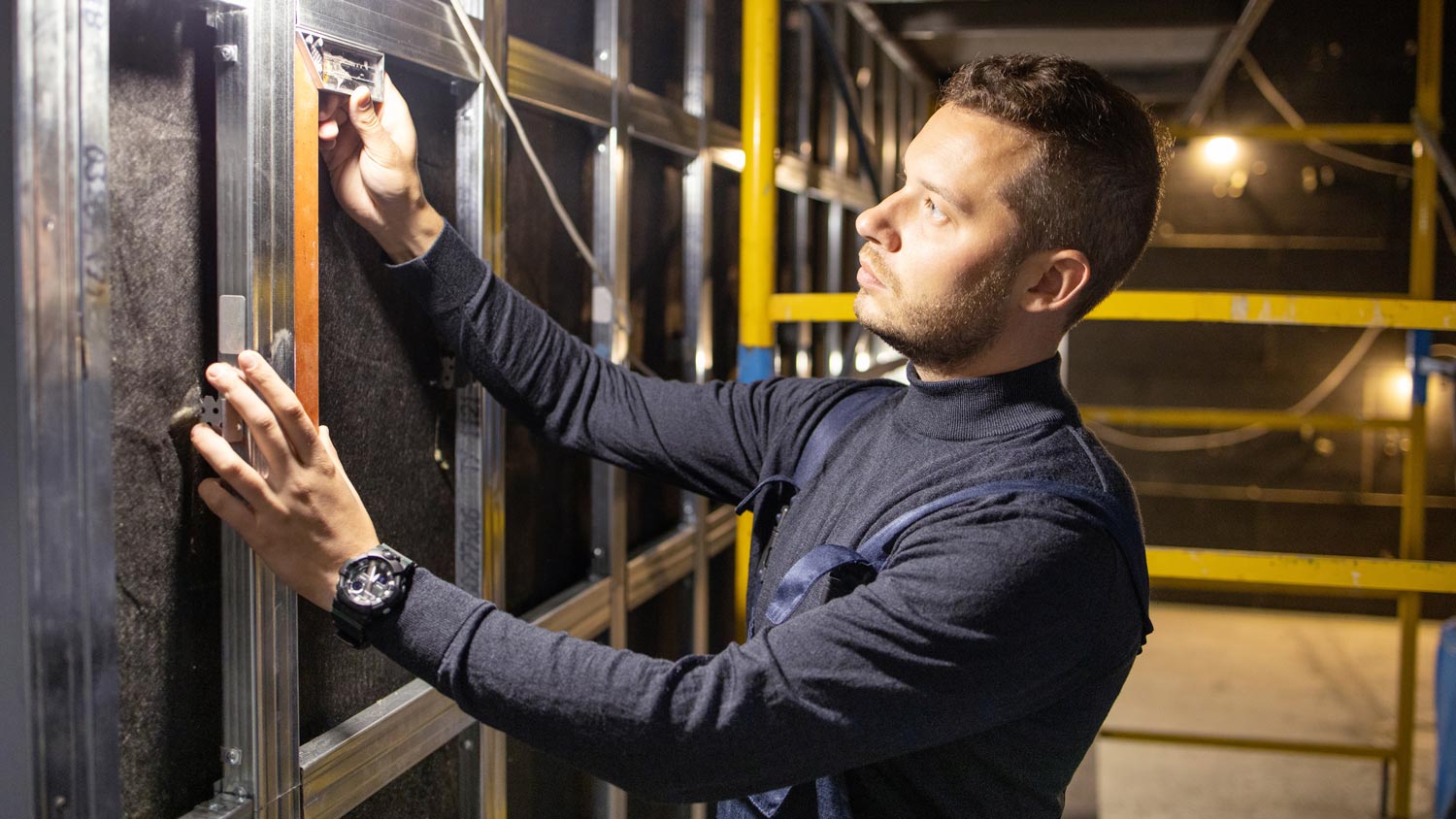 A professional installing a soundproofing wall