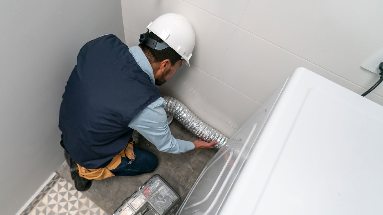 A professional installing a vented dryer