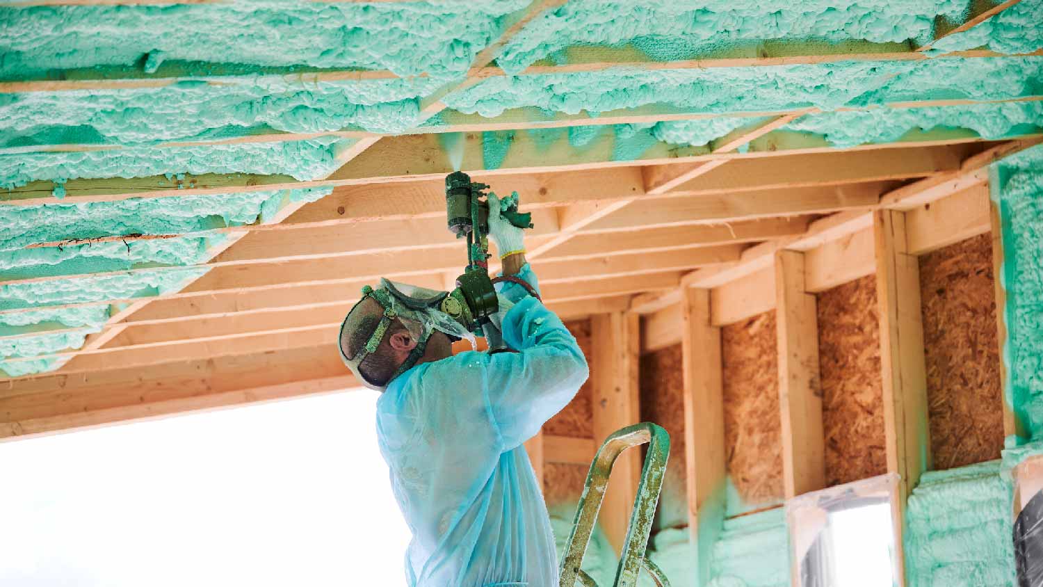 A professional insulating between rafters