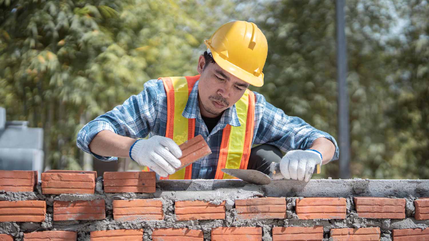 A professional laying bricks