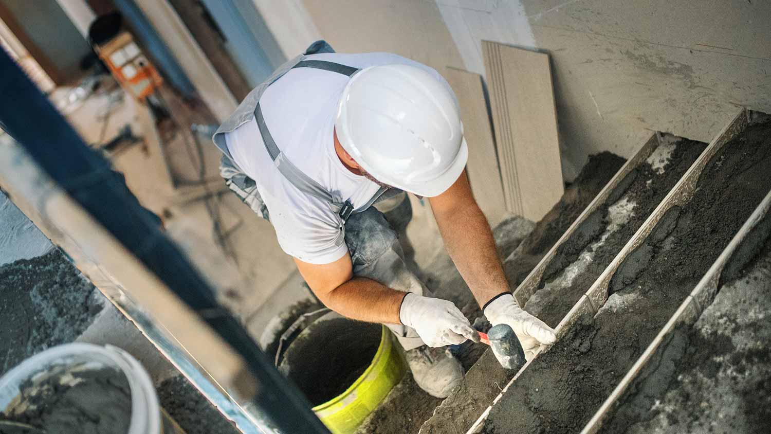 A professional laying concrete stairs
