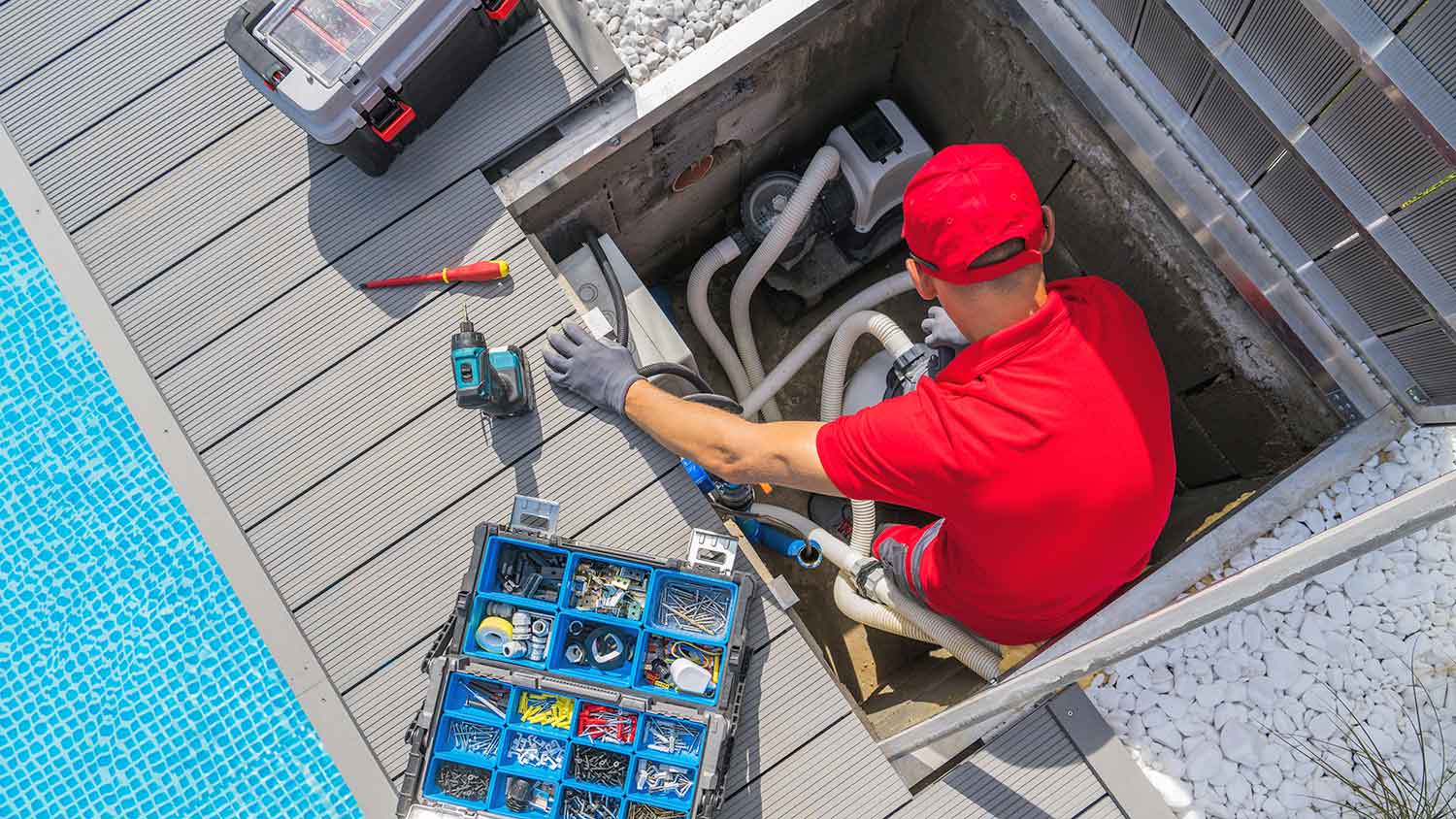 Technician checking swimming pool plumbing