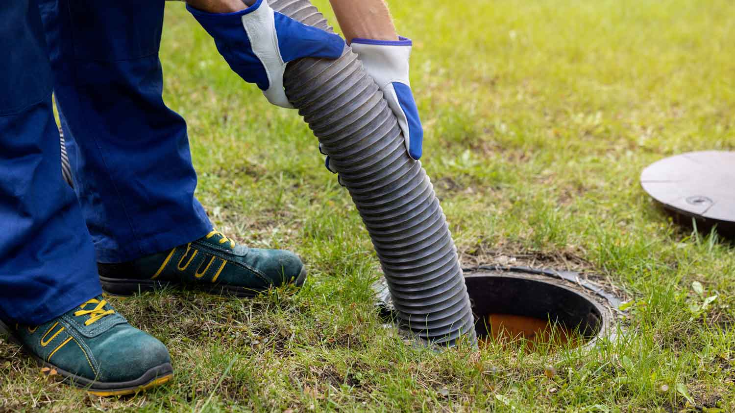 A professional pumping out a septic tank