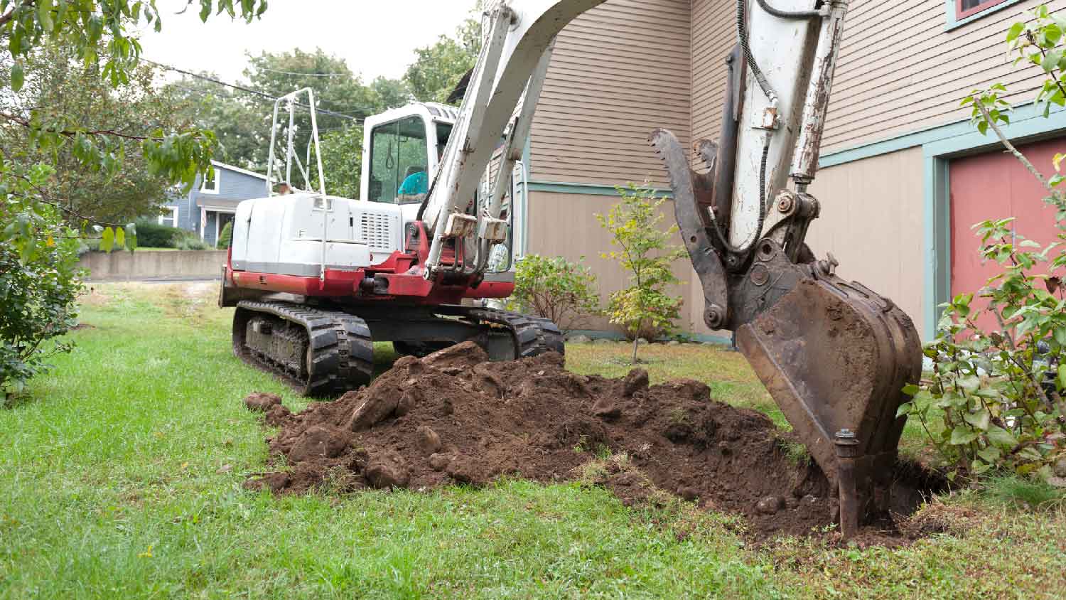 A professional removing the lawn from the garden