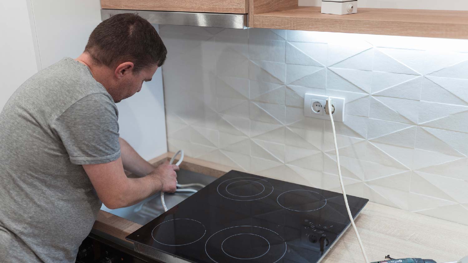 A professional repairing an electric stove