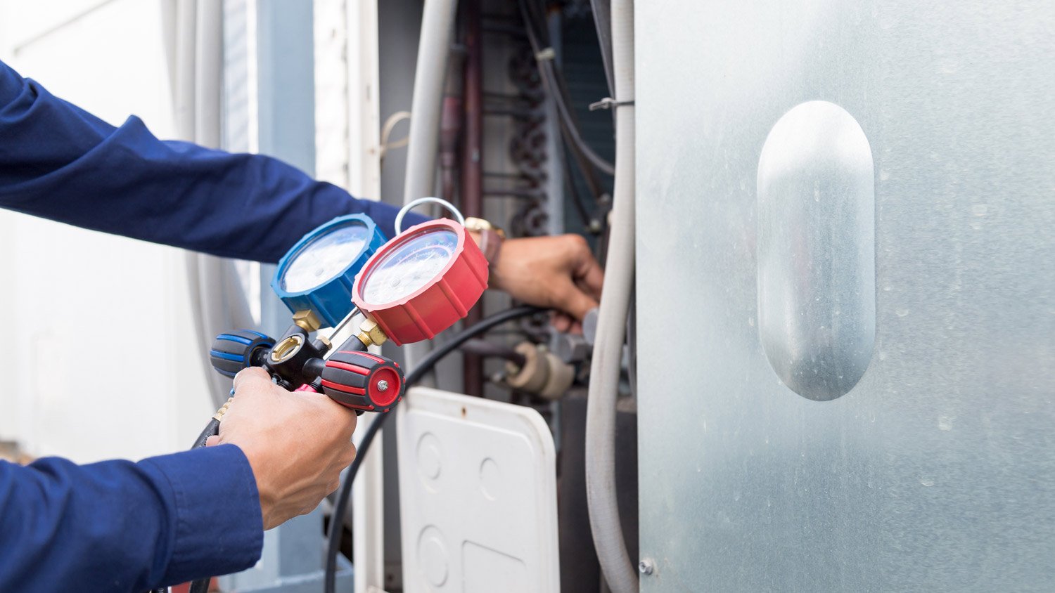 Close-up of a professional repairing a heat pump