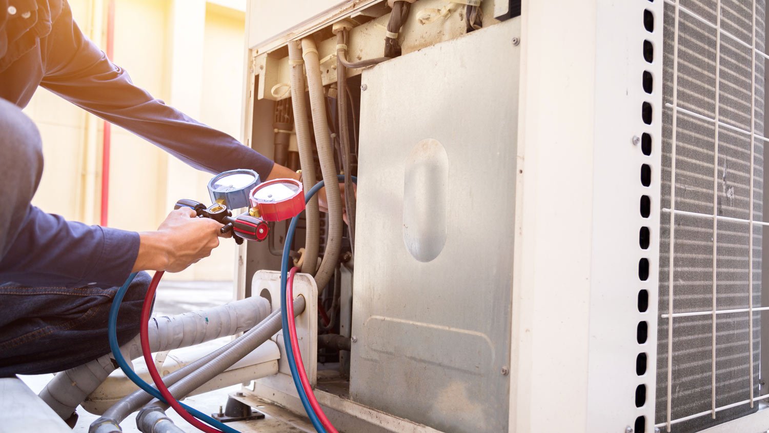 A professional repairing a HVAC system