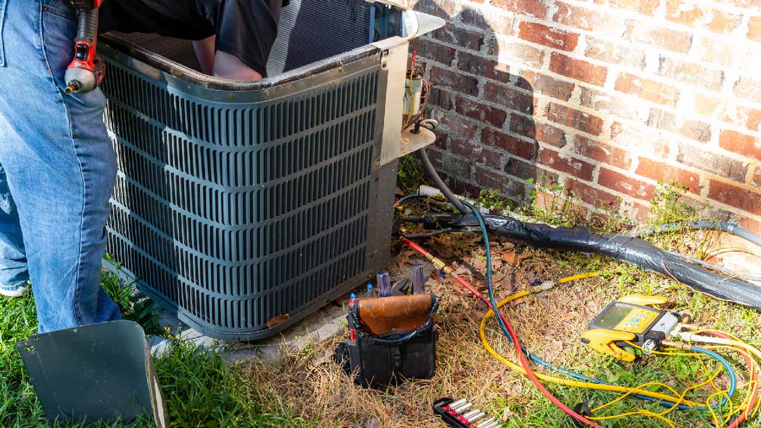 A professional repairing a HVAC unit