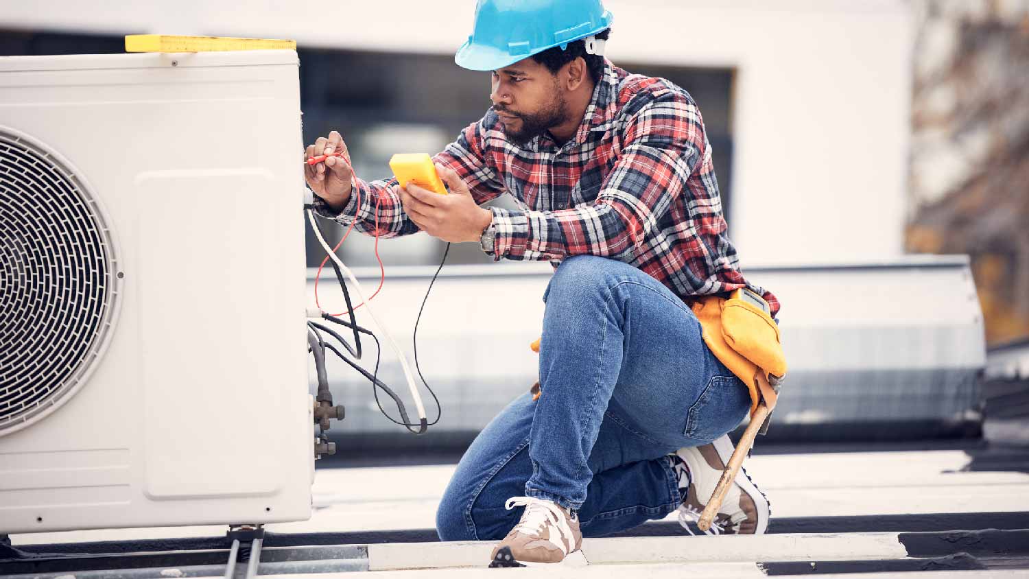 A professional repairing a HVAC’s wiring