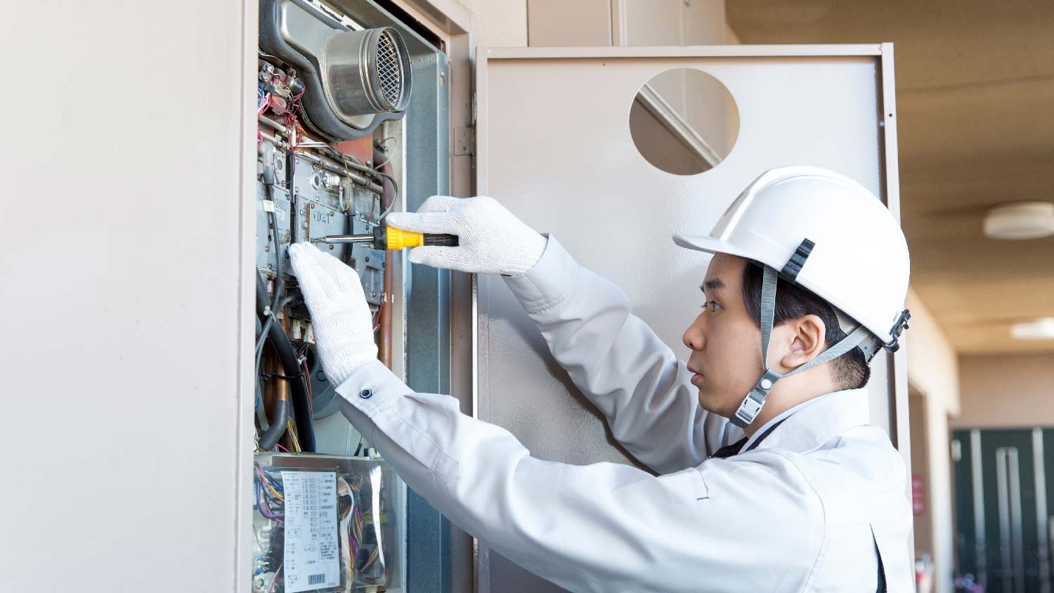 A professional repairing a tankless hot water heater