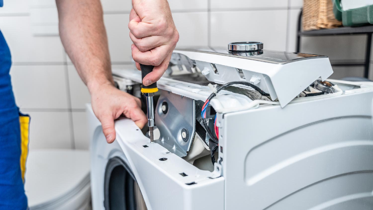 A professional repairing a washing machine