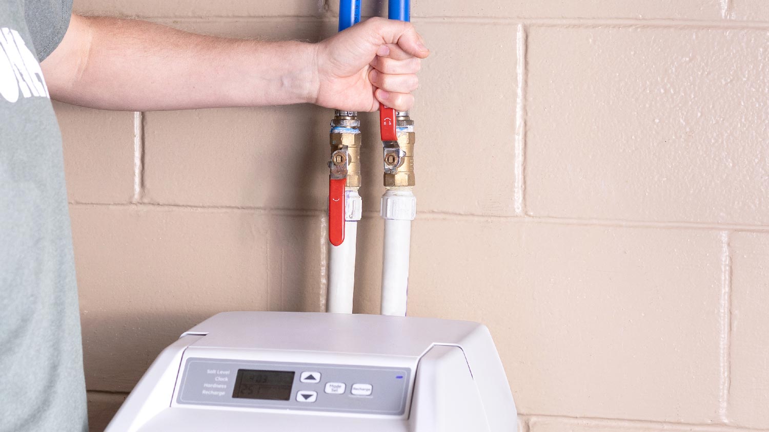 A professional repairing a water softener