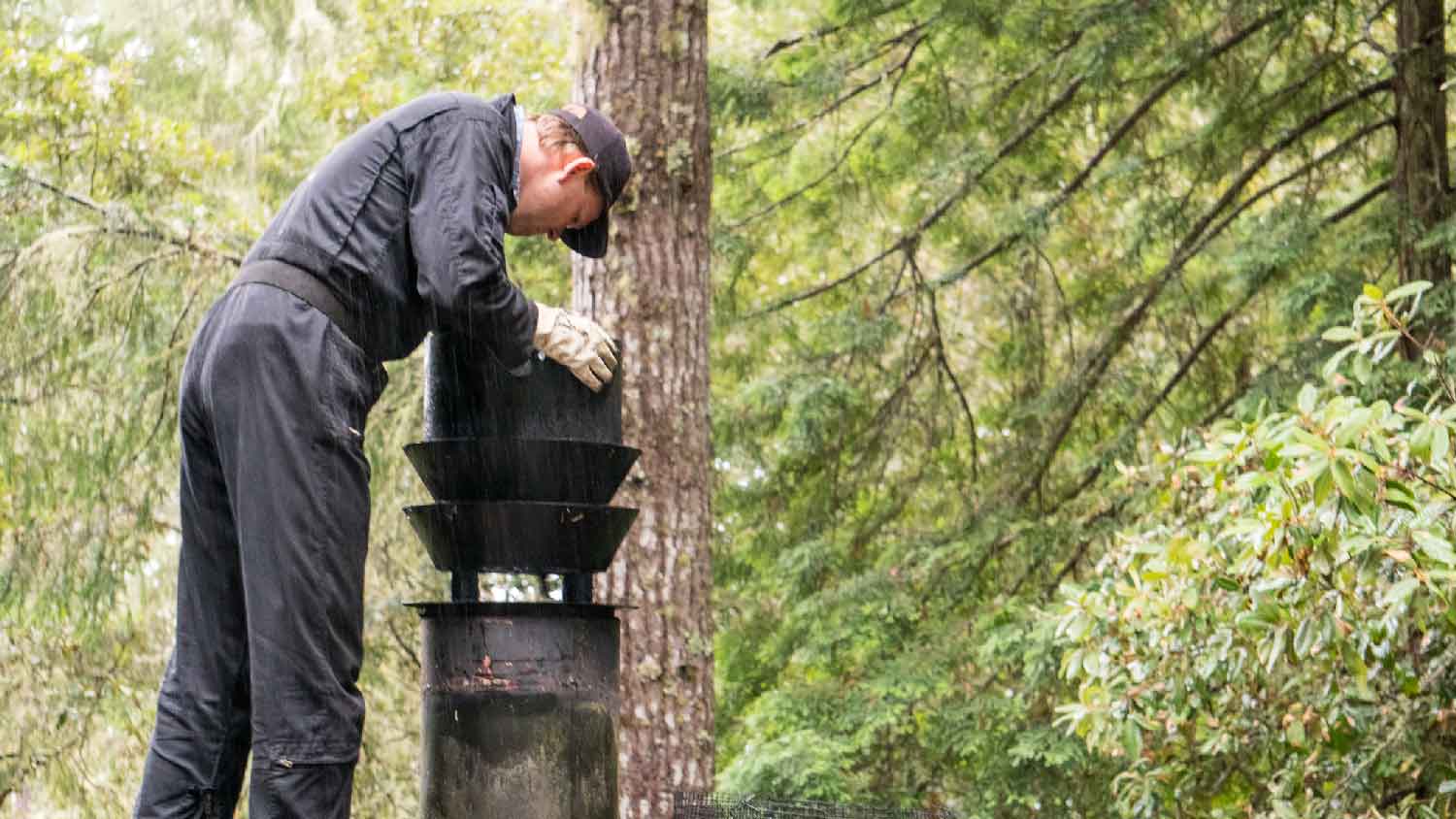 A professional sweep cleaning the chimney 