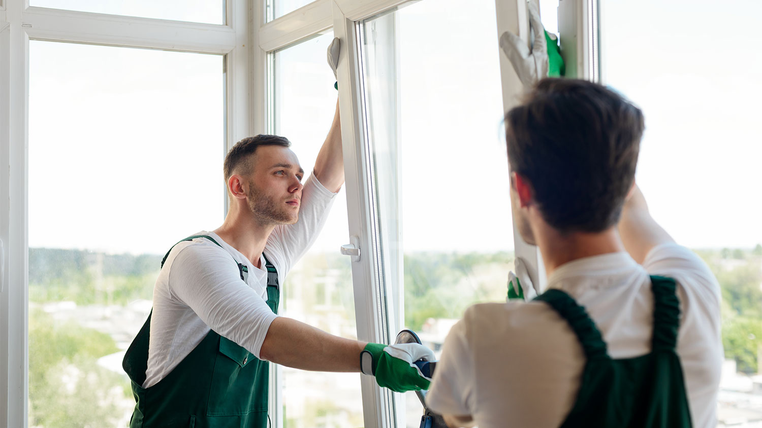 professionals installing new window in home