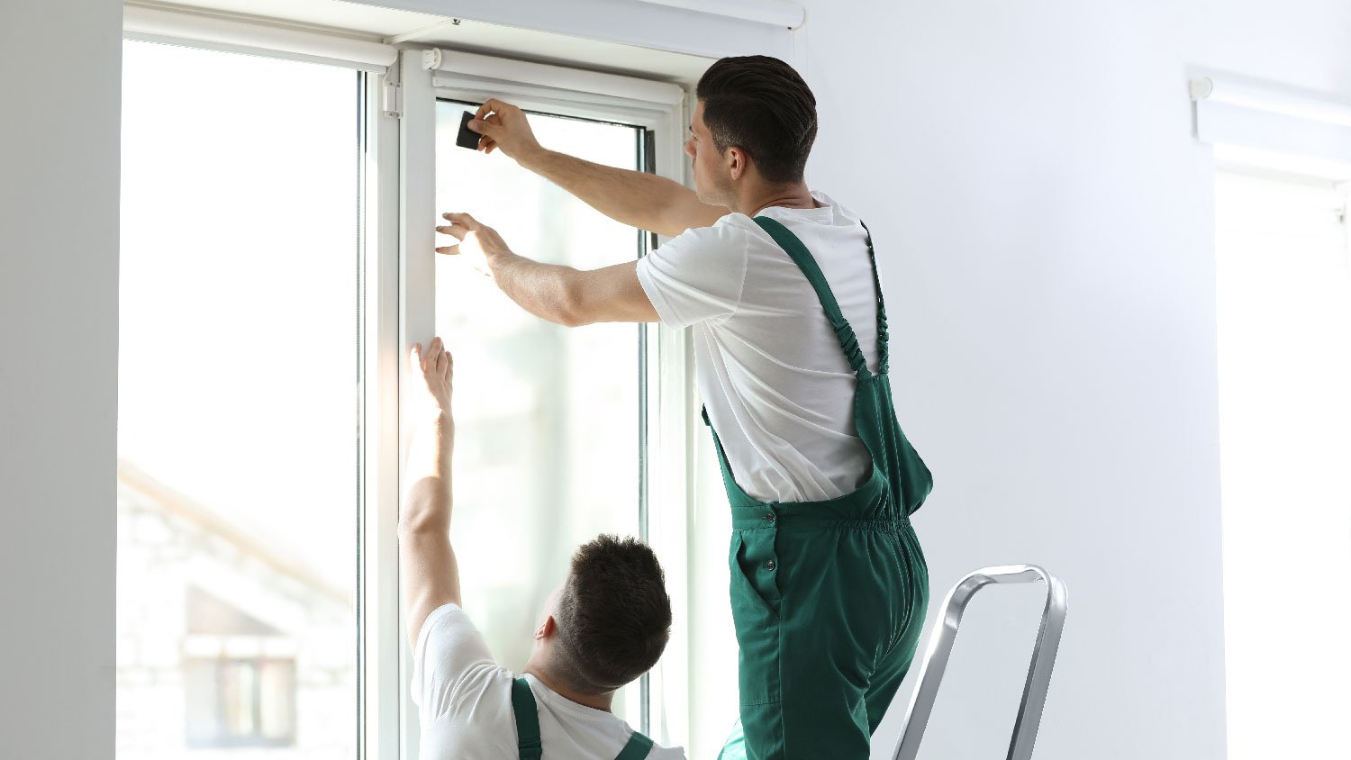 Professionals applying window film