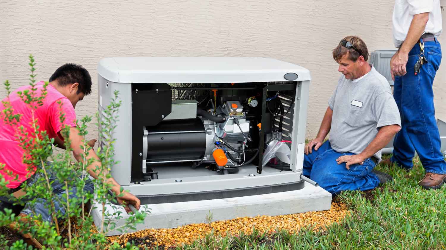 A group of professionals installing a standby generator