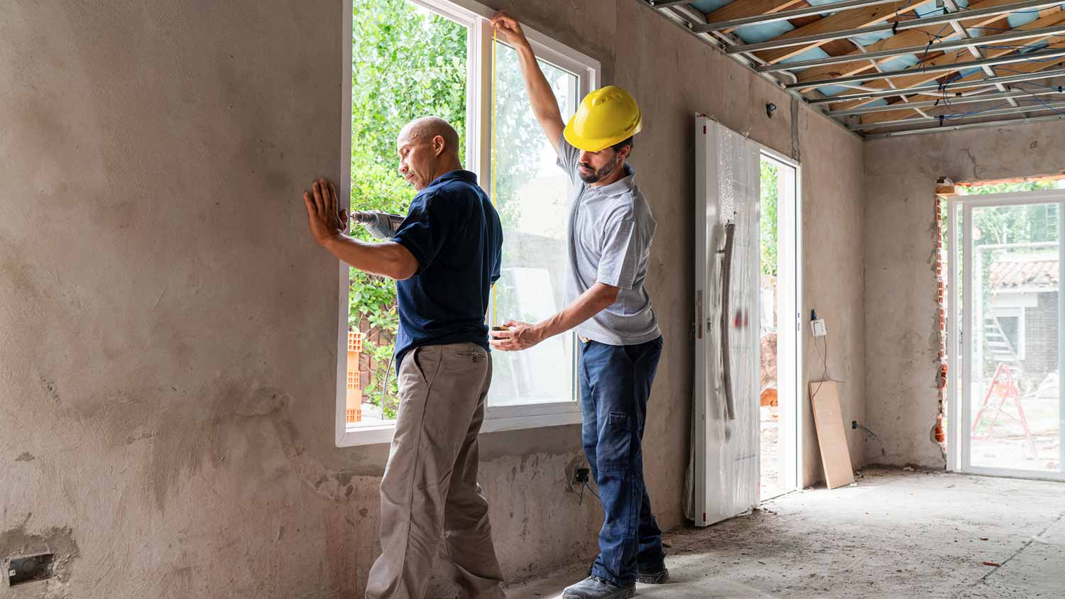 Two professionals installing a window