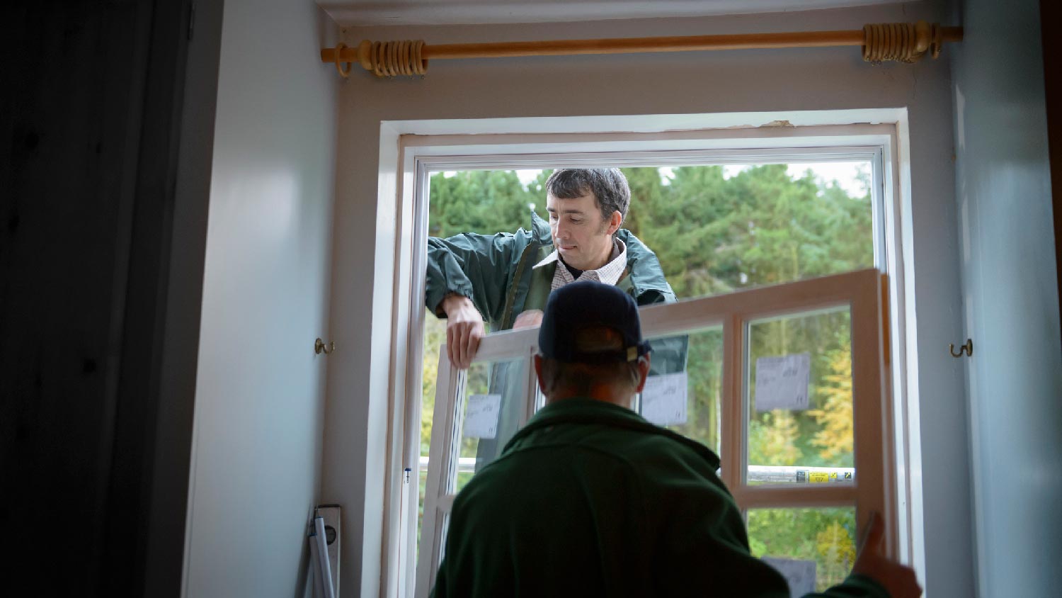 Professionals installing a window 