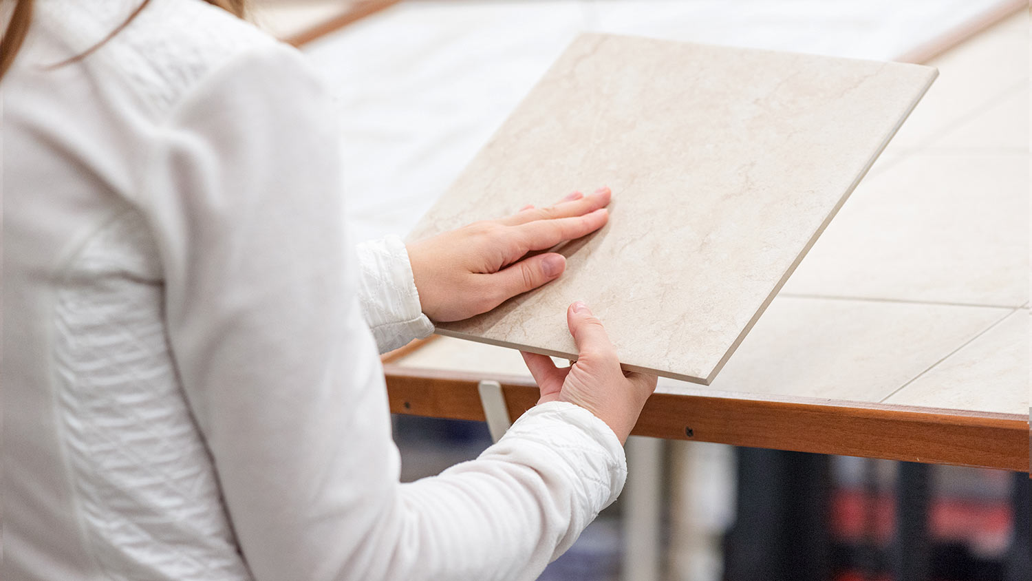 Woman choosing a new floor tile