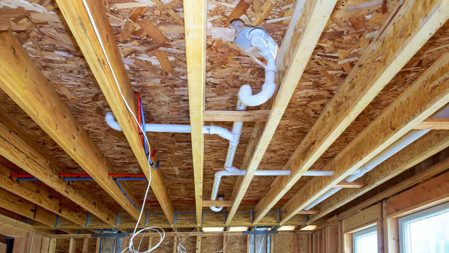 Visible PVC sewer pipe system inside the building