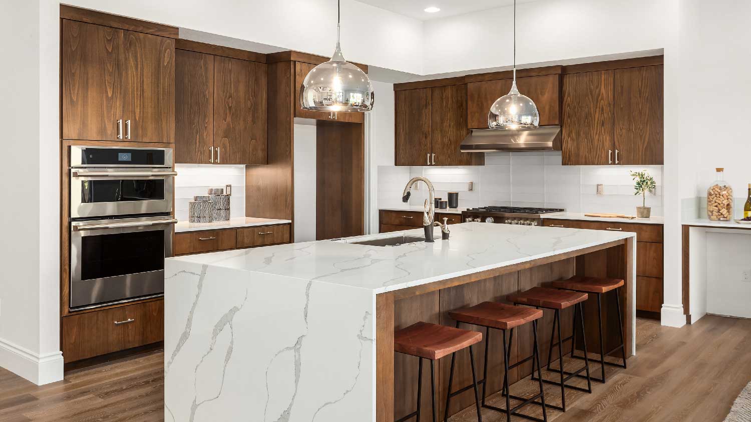 A kitchen with a quartz waterfall countertop