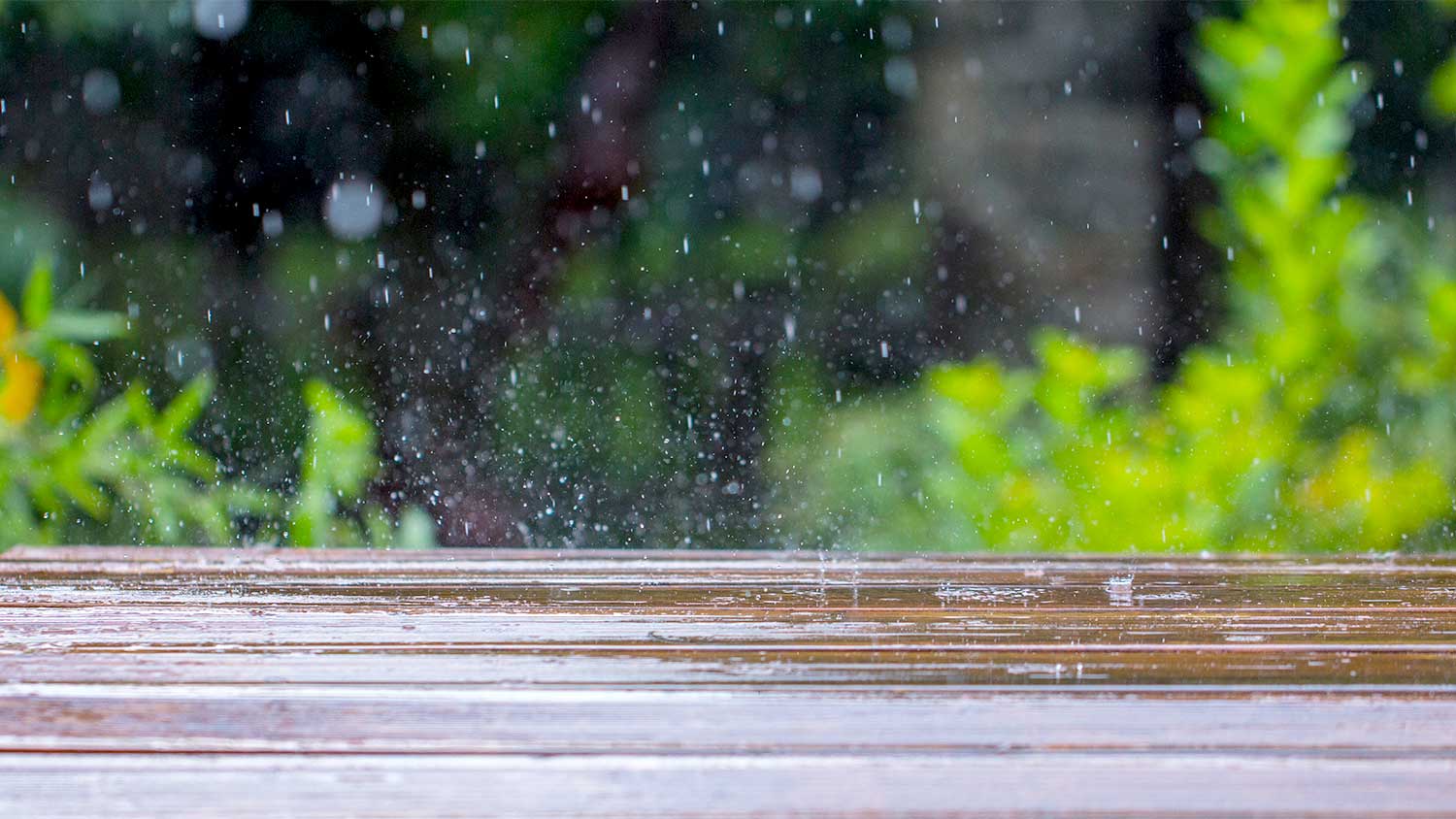 Closeup of rain falling on a deck