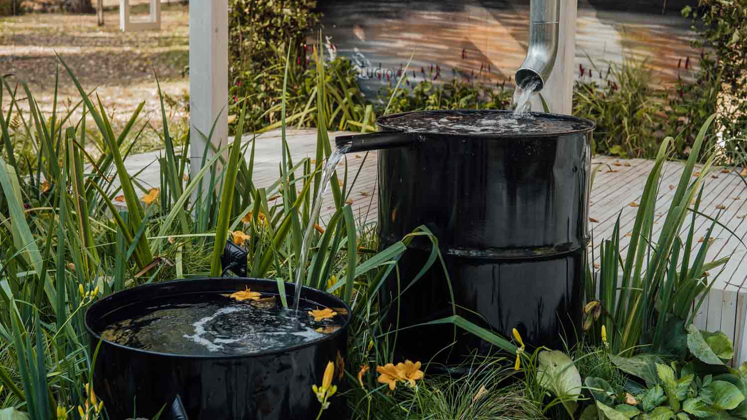 rain water flowing in metal barrel  