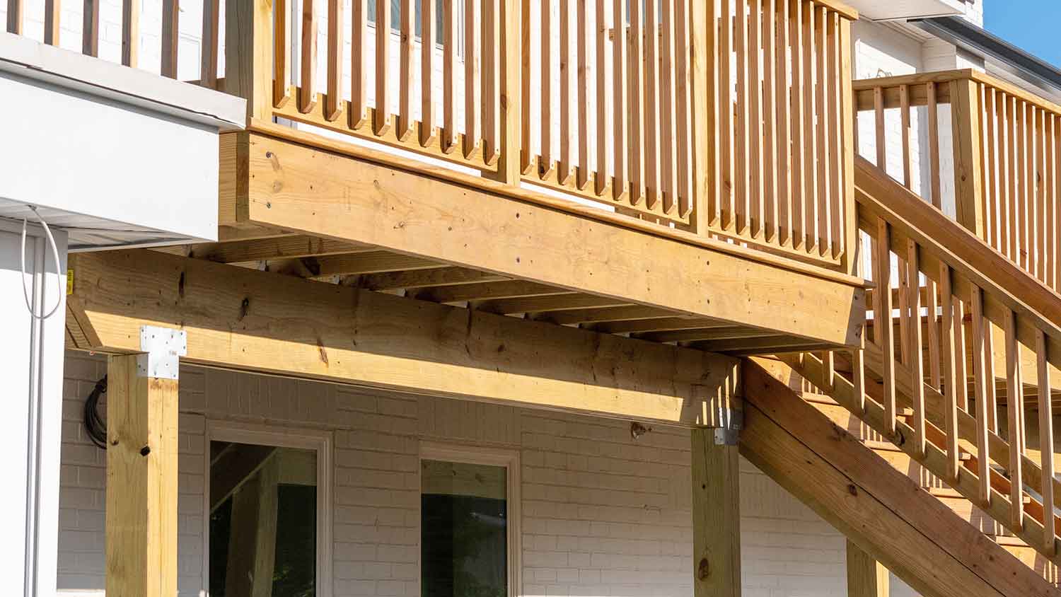 Raised wooden deck attached to the house