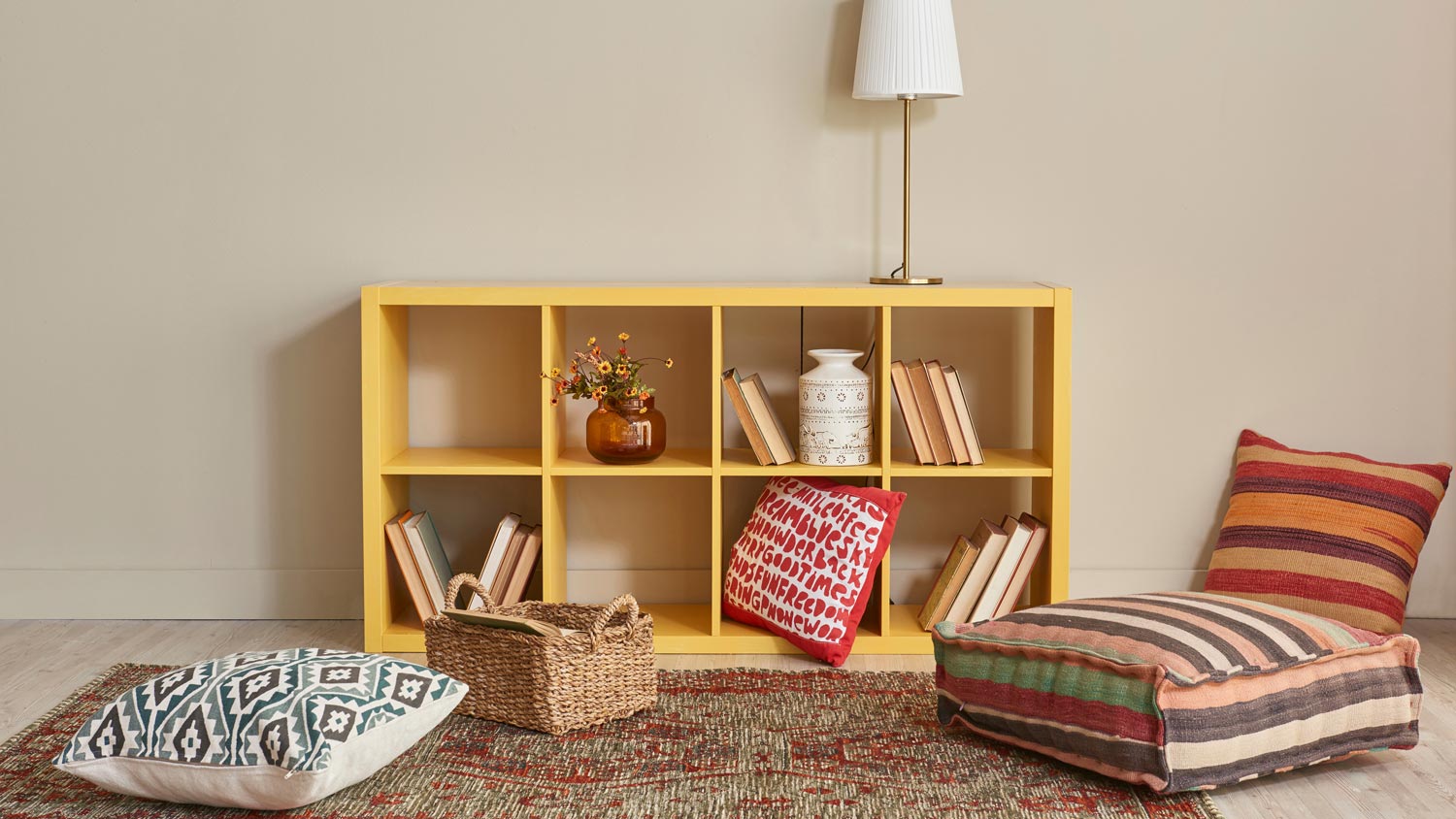 A reading nook with pillows on the floor