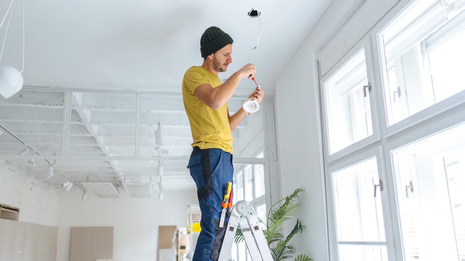 Electrician fixing ceiling lights