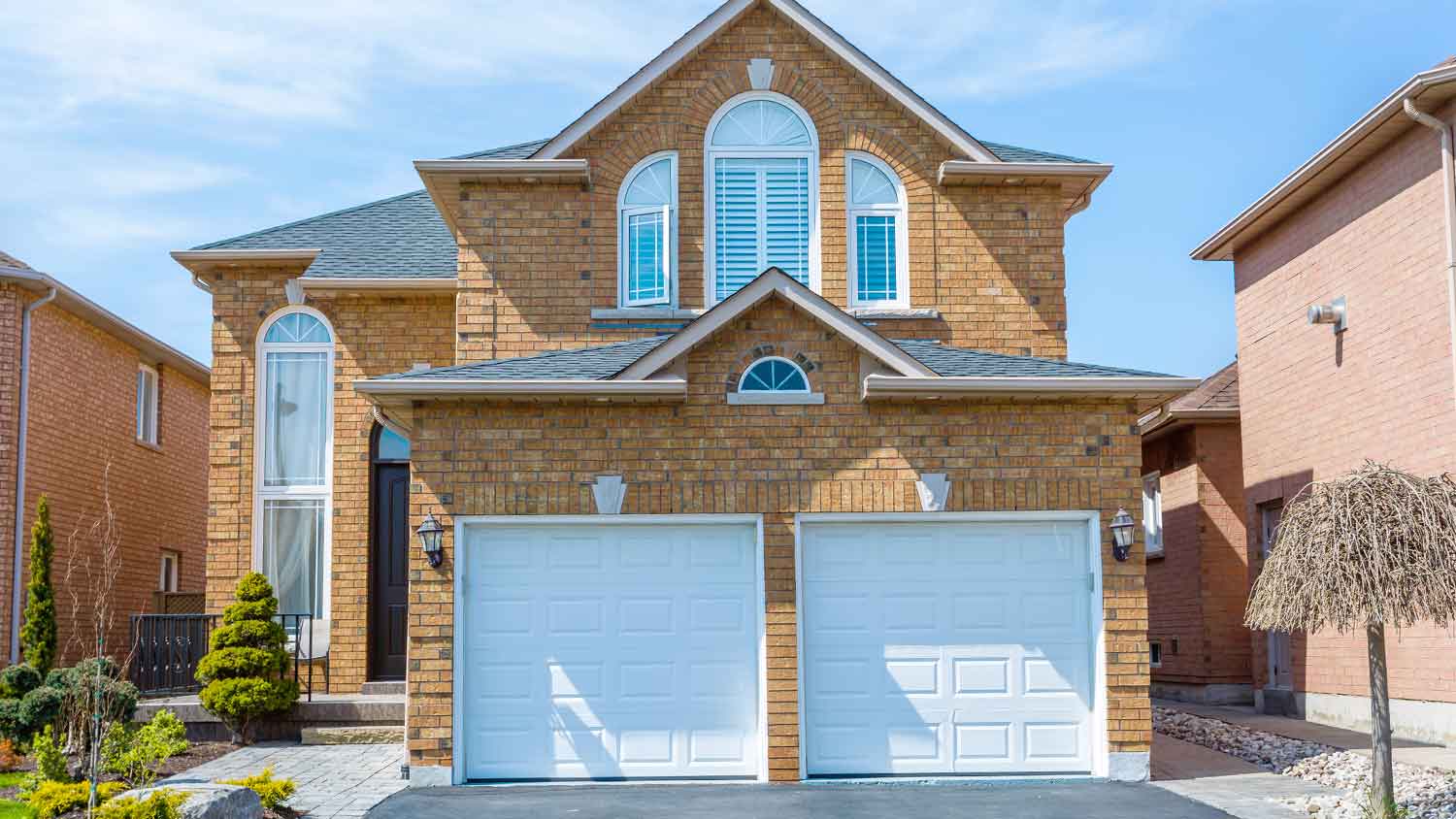 Brick cladding installed on a two-story suburban house 