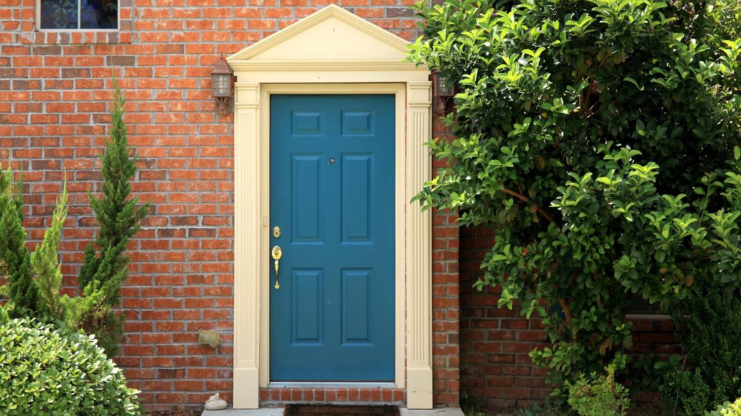 Red brick house with a blue front door