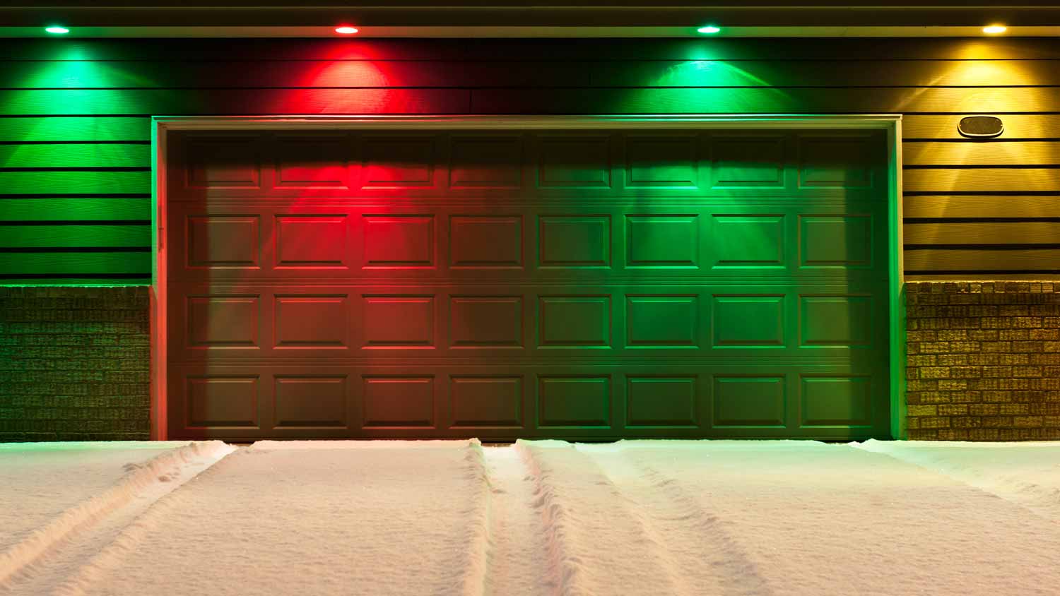 Red and green projection lights above a garage door