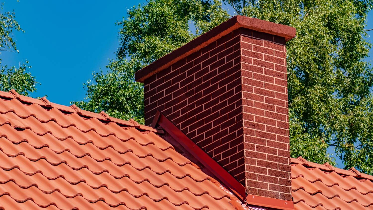 A red tiled chimney on a roof