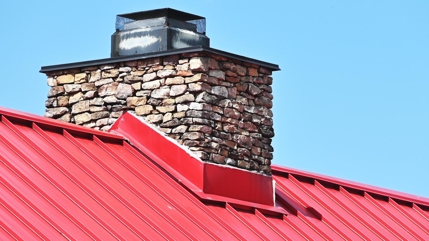 Close-Up Of Brick Chimney On House Roof With medal flashing