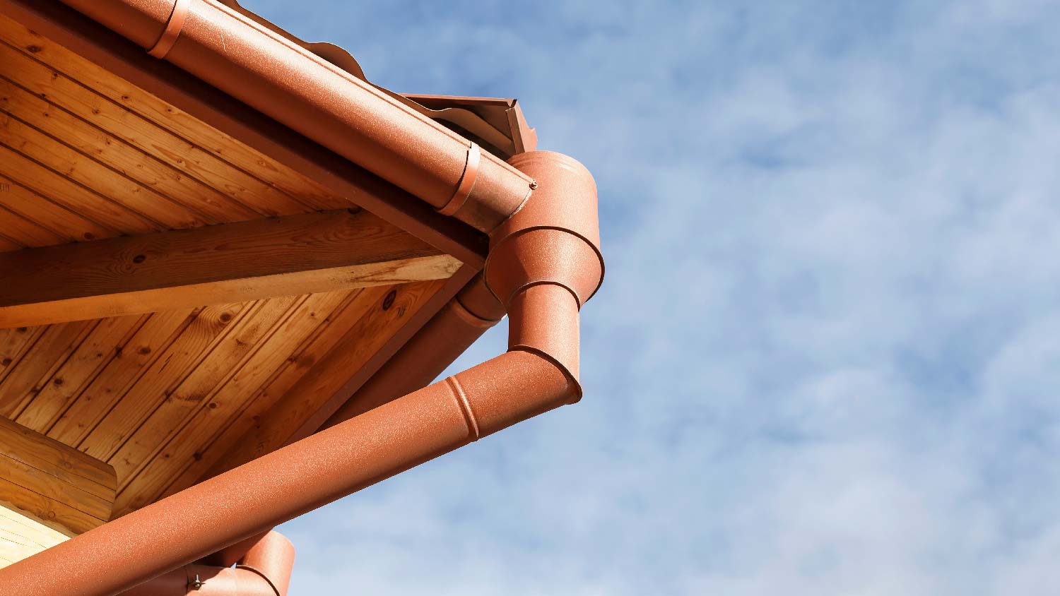 A house with a gutter and a redwood soffit