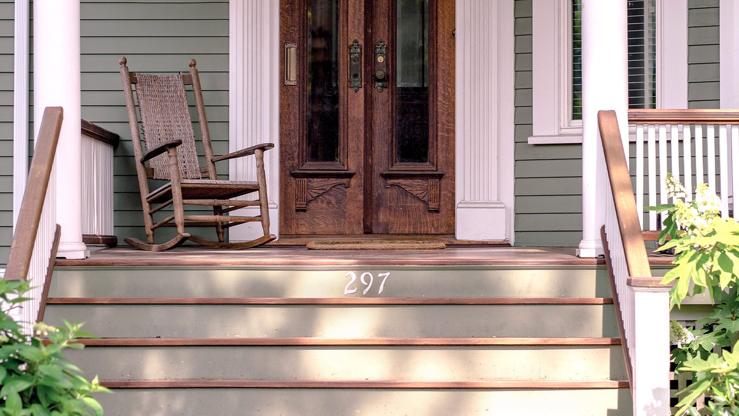 front porch with steps and rocking chair by front door