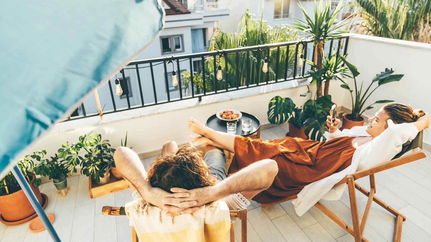 Couple enjoying the sun and relaxing on the balcony